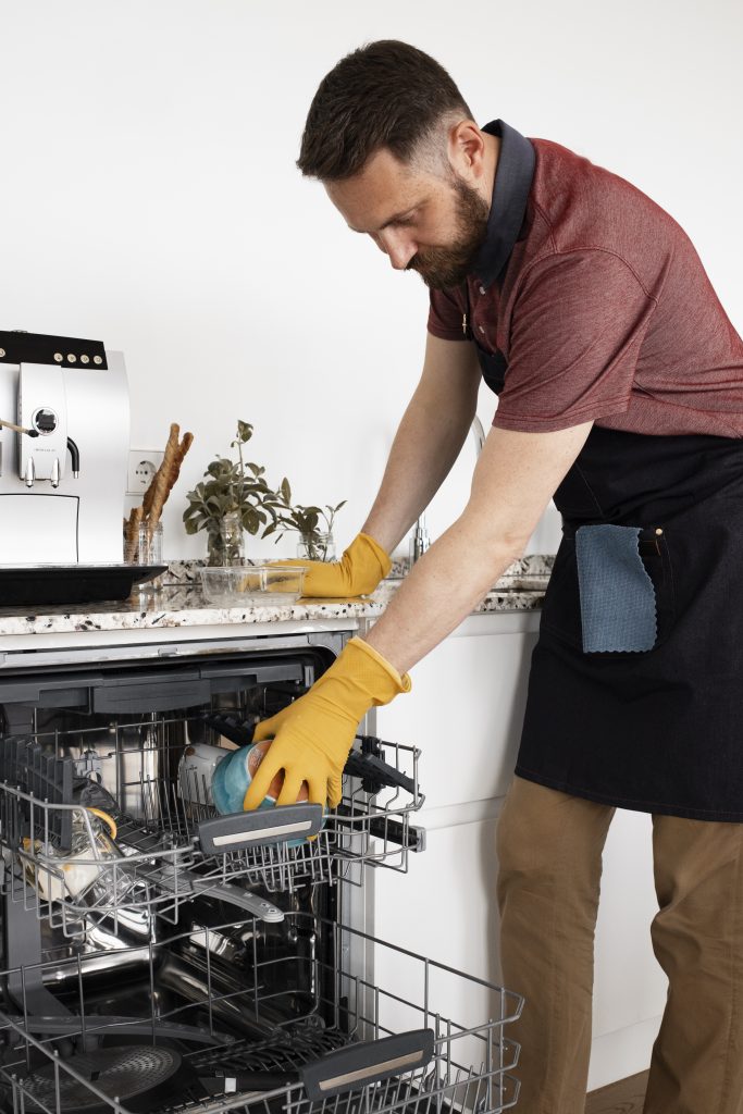 man servant cleaning kitchen scaled
