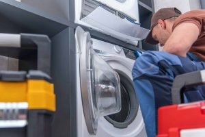 broken washing machine and problem fixing by technician